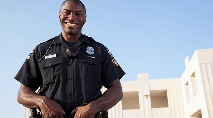security guard smiling in front of building